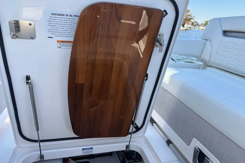 Slide: The Image of 2026 Tiara Yachts 34 LS interior with wooden panel and seating detail. - 27