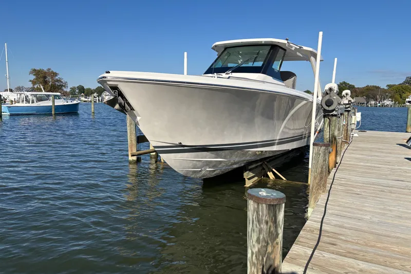 The Image of 2026 Tiara Yachts 34 LS docked at a marina on a sunny day. - 0