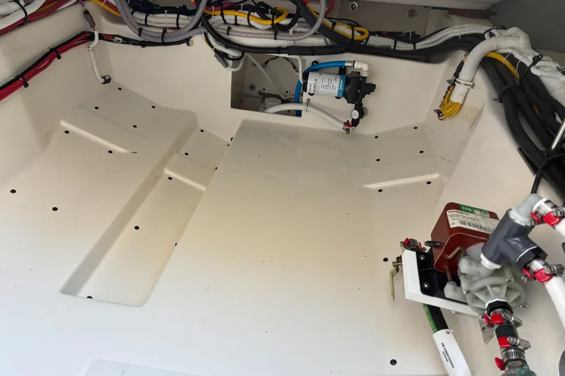 Slide: The Image of Engine compartment of 2026 Tiara Yachts 34 LS, showcasing wiring and components. - 26