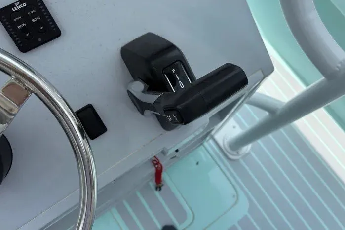 Slide: The Image of Control panel of a 2024 Exuma 22 boat with steering wheel and throttle lever. - 21