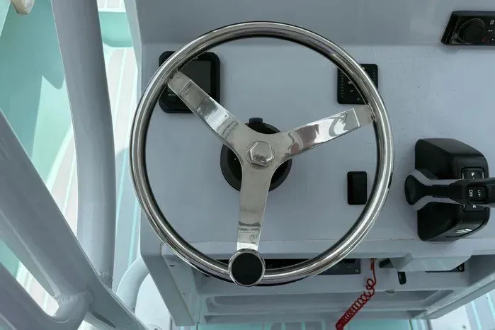 Slide: The Image of Steering wheel and controls of 2024 Exuma 22 boat, showcasing modern design. - 17