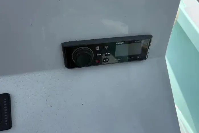 Slide: The Image of Control panel on 2024 Exuma 22 boat dashboard, featuring a Fusion stereo system. - 20