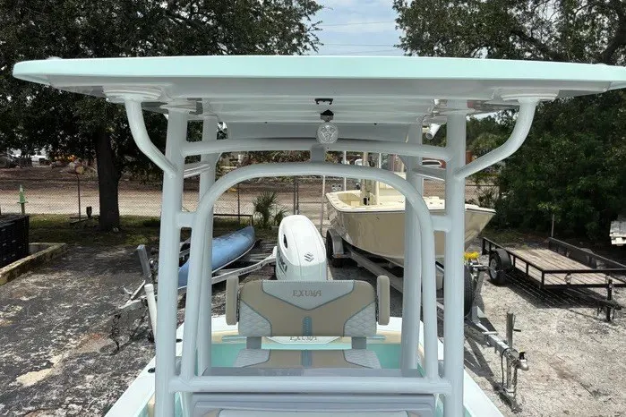 Slide: The Image of 2024 Exuma 22 boat with T-top and seating, parked outdoors. - 25