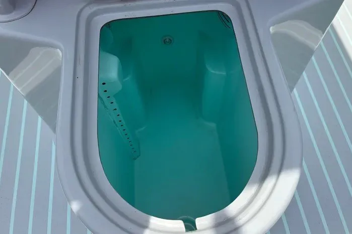 Slide: The Image of Boat livewell on 2024 Exuma 22 model, featuring a turquoise interior. - 15