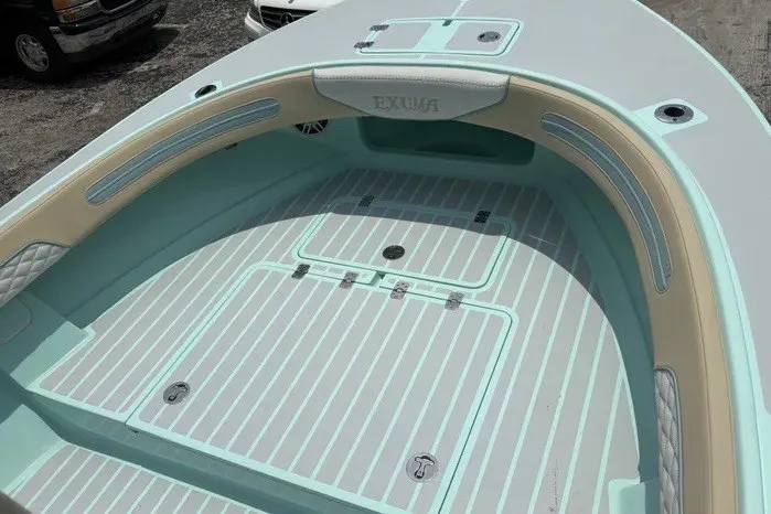 Slide: The Image of 2024 Exuma 22 boat interior with light blue and beige accents, featuring a spacious deck. - 23