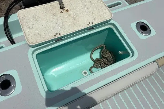 Slide: The Image of An Exuma 22 boat from 2024 with an open storage compartment containing a rope. - 33