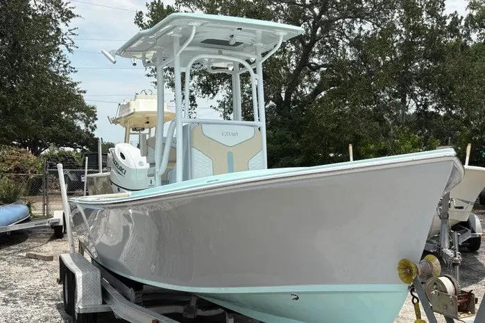 The Image of 2024 Exuma 22 boat on trailer, sleek design, light blue and white color scheme. - 0
