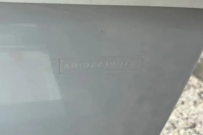 Slide: The Image of Close-up of a 2024 Exuma 22 hull identification number on a gray surface. - 31