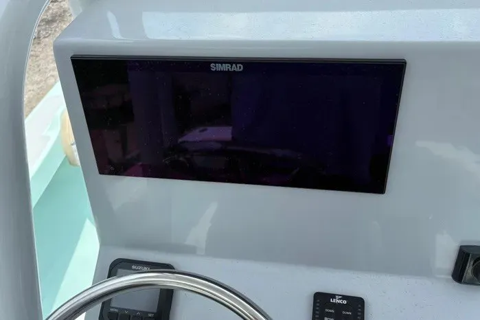 Slide: The Image of Dashboard of 2024 Exuma 22 boat featuring Simrad display and controls. - 18