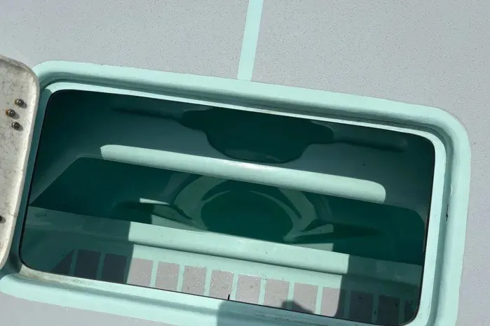 Slide: The Image of Open hatch on 2024 Exuma 22 boat deck, showcasing interior compartment. - 34