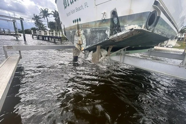 Slide: The Image of Boat lift holding Shamrock 290 Walkaround, 2000 model, over water in North Palm Beach, FL. - 10