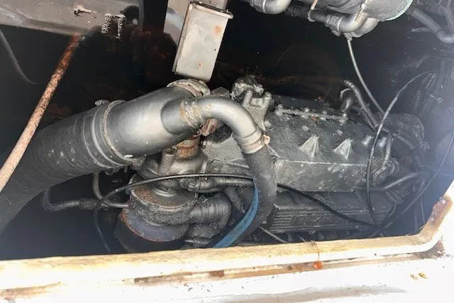 Slide: The Image of Engine compartment of a 2000 Shamrock 290 Walkaround boat, showing mechanical components. - 12