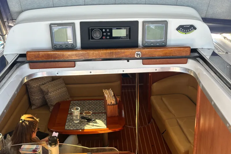 Slide: The Image of 2008 Hunter 41 Deck Salon interior with navigation equipment and cozy seating area. - 33
