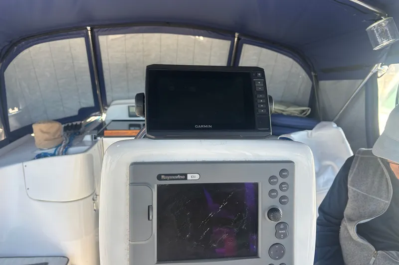 Slide: The Image of 2008 Hunter 41 Deck Salon cockpit with Garmin and Raymarine navigation systems. - 4
