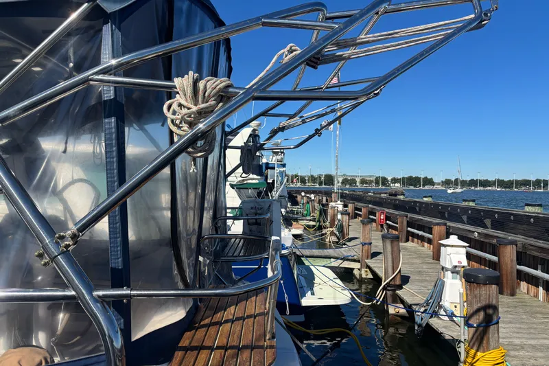 Slide: The Image of 2008 Hunter 41 Deck Salon yacht docked at marina, showcasing sleek design and nautical equipment. - 32