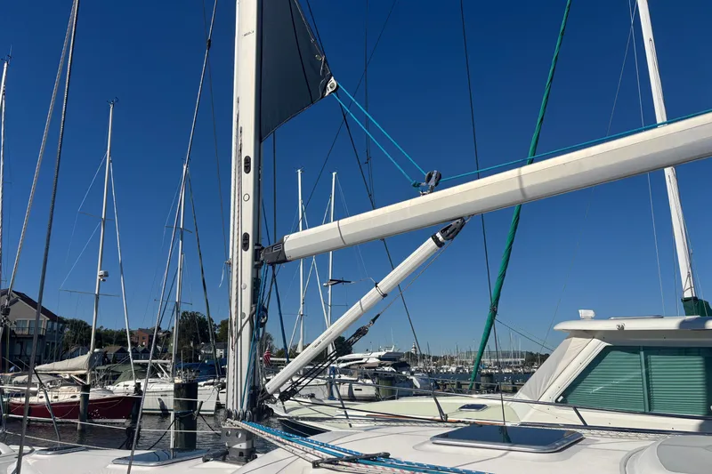Slide: The Image of 2008 Hunter 41 Deck Salon sailboat docked at marina under clear blue sky. - 28