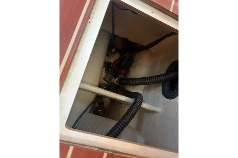 Slide: The Image of Bilge compartment of 2008 Hunter 41 Deck Salon with visible wiring and hoses. - 25