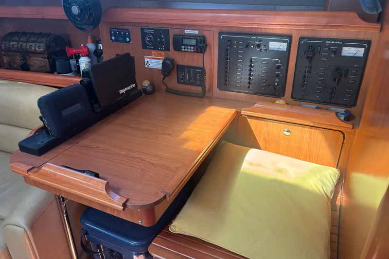 Slide: The Image of Navigation station on 2008 Hunter 41 Deck Salon yacht with control panels and equipment. - 17