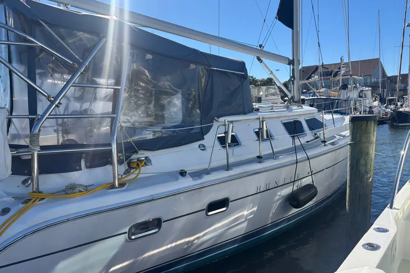 Slide: The Image of Sailboat Hunter 41 Deck Salon 2008 docked at marina under clear blue sky. - 1