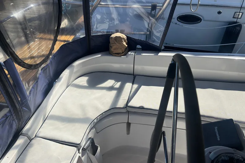 Slide: The Image of 2008 Hunter 41 Deck Salon cockpit with cushioned seating and steering wheel. - 9