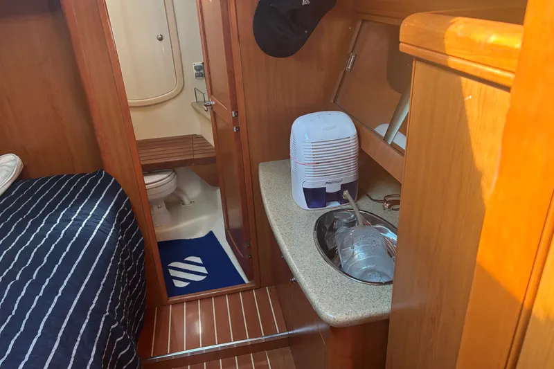 Slide: The Image of Interior of 2008 Hunter 41 Deck Salon with bathroom and countertop amenities. - 19