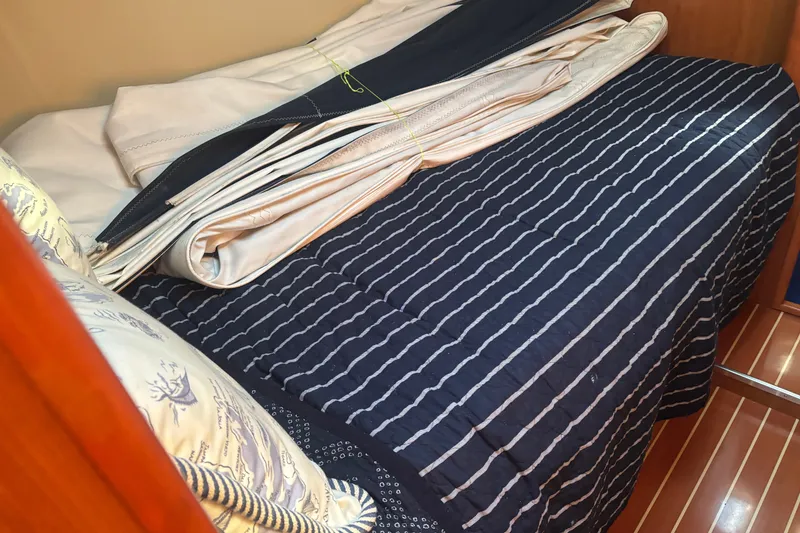 Slide: The Image of Cozy cabin interior of 2008 Hunter 41 Deck Salon with striped bedding and folded sails. - 18