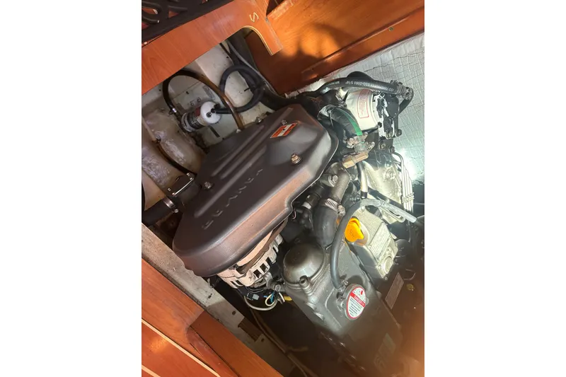 Slide: The Image of Engine compartment of a 2008 Hunter 41 Deck Salon sailboat, showcasing mechanical components. - 13