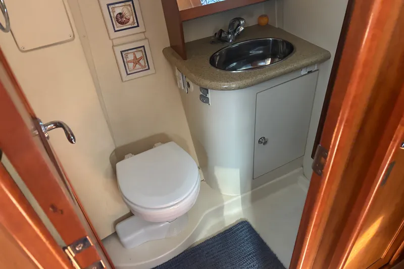 Slide: The Image of 2008 Hunter 41 Deck Salon bathroom with sink, toilet, and decorative wall art. - 24