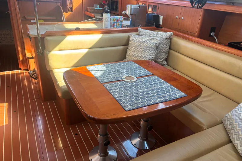 Slide: The Image of Interior of 2008 Hunter 41 Deck Salon with dining area and wooden table. - 20
