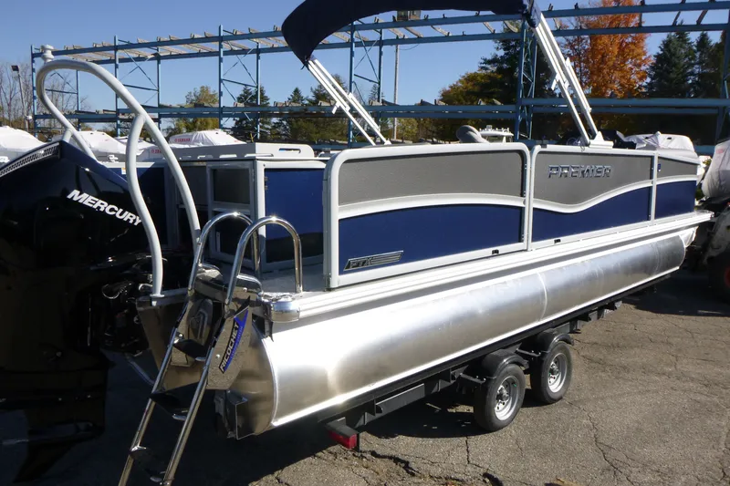 Slide: The Image of 2027 Premier 230 Sunsation Angler 2PT - CL pontoon boat on trailer, featuring Mercury engine. - 2