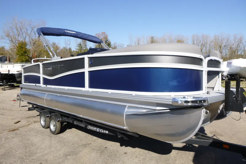 The Image of 2027 Premier 230 Sunsation Angler 2PT - CL pontoon boat on trailer, blue and silver design. - 0