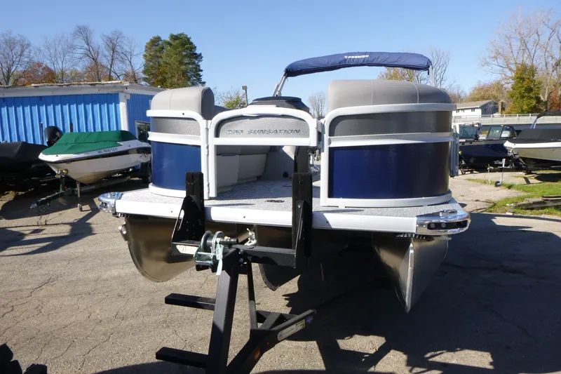 Slide: The Image of 2027 Premier 230 Sunsation Angler 2PT - CL pontoon boat on trailer, outdoor setting. - 12