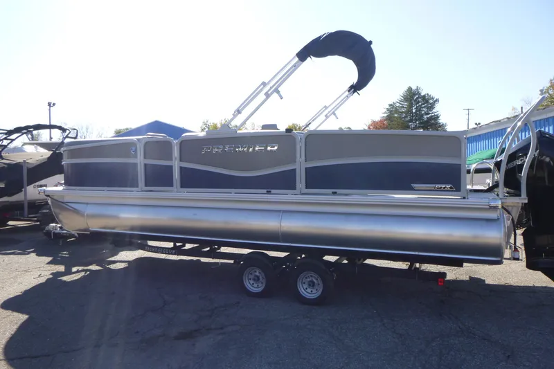 Slide: The Image of 2027 Premier 230 Sunsation Angler 2PT - CL pontoon boat on trailer, side view. - 7