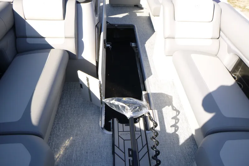 Slide: The Image of Interior view of 2027 Premier 230 Sunsation Angler 2PT - CL boat with open storage compartment. - 19
