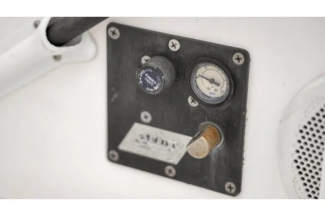 Slide: The Image of Control panel on a 2005 J Boats J/100 sailboat, featuring gauges and switches. - 11