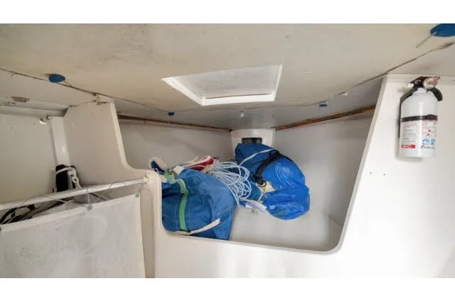 Slide: The Image of Interior of 2005 J Boats J/100 sailboat with storage area and fire extinguisher. - 22
