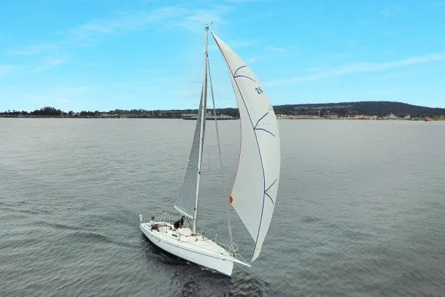 Slide: The Image of Sailing yacht J Boats J/100 2005 gliding on calm waters under a clear blue sky. - 40