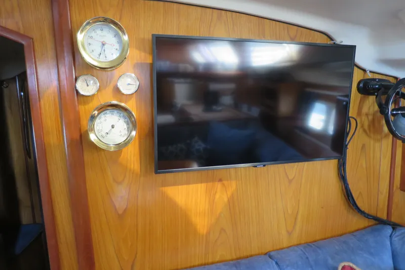 Slide: The Image of Interior of 2000 Hunter Legend 410 yacht with wall-mounted TV and nautical instruments. - 21