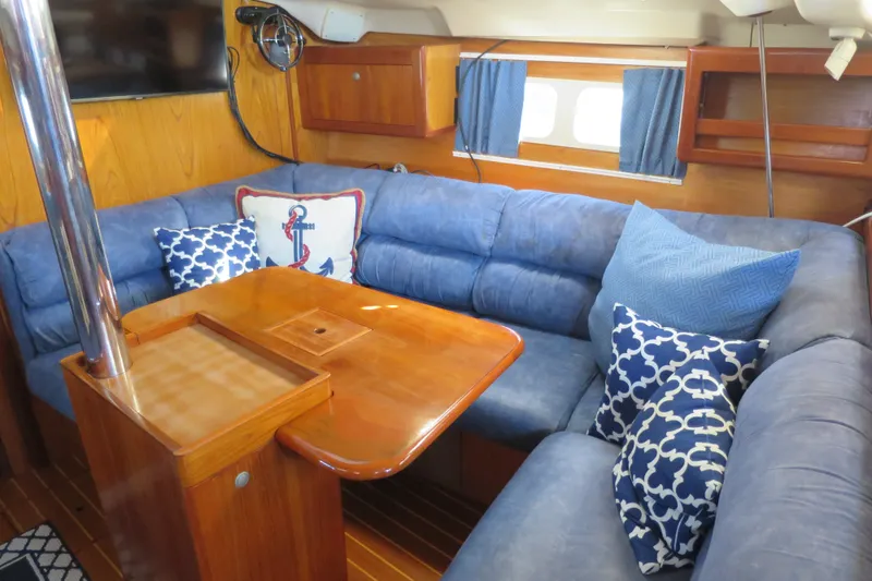Slide: The Image of Cozy interior of 2000 Hunter Legend 410 yacht with blue seating and nautical decor. - 16