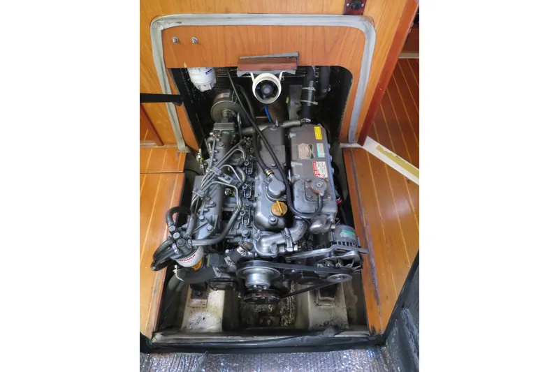 Slide: The Image of Engine compartment of a 2000 Hunter Legend 410 sailboat, showcasing detailed mechanics. - 22