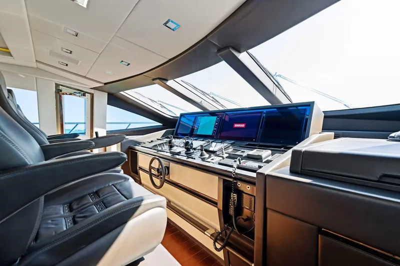 Slide: The Image of Luxurious 2016 Mangusta 94 yacht cockpit with advanced navigation systems and plush seating. - 5