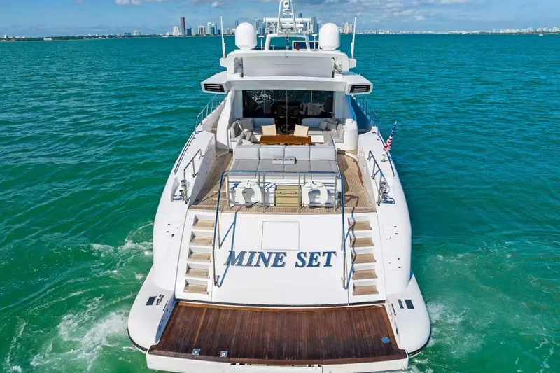 Slide: The Image of Luxury 2016 Mangusta 94 yacht on open sea, rear view with deck and seating area. - 16