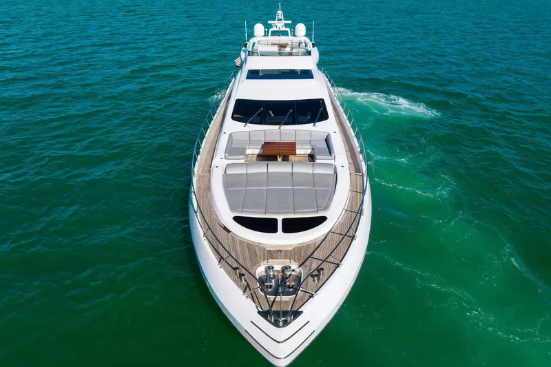Slide: The Image of Luxurious 2016 Mangusta 94 yacht cruising on clear blue waters. - 11