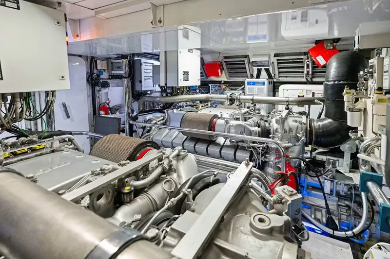 Slide: The Image of Engine room of a 2016 Mangusta 94 yacht, showcasing complex machinery and equipment. - 17