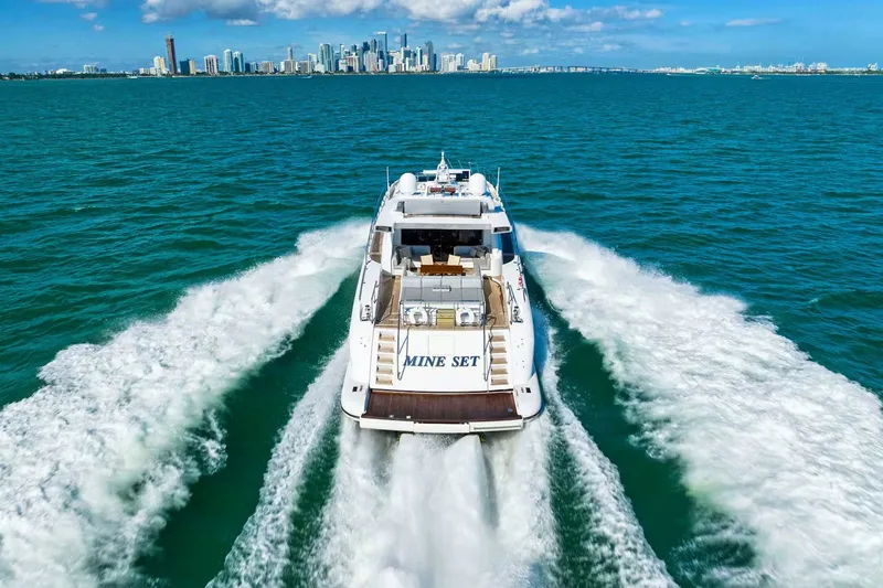 Slide: The Image of Luxurious 2016 Mangusta 94 yacht cruising near city skyline on a sunny day. - 3