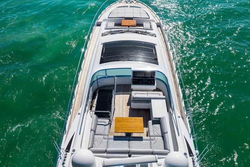 Slide: The Image of Luxurious 2016 Mangusta 94 yacht cruising on vibrant turquoise waters. - 12