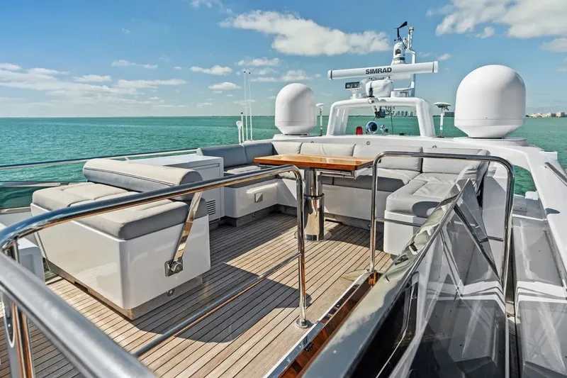 Slide: The Image of Luxurious 2016 Mangusta 94 yacht deck with seating, overlooking serene ocean waters. - 14