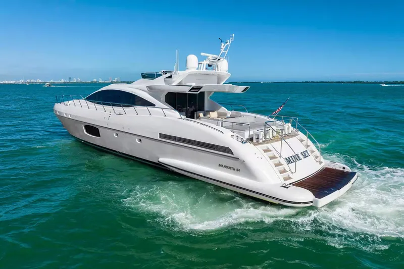 Slide: The Image of Luxury 2016 Mangusta 94 yacht cruising on clear blue waters. - 18