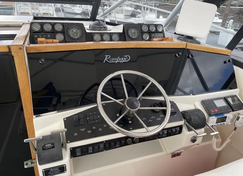 Slide: The Image of The cockpit of a 1993 Rampage Express Sportfish with a steering wheel and instrument panels. - 14