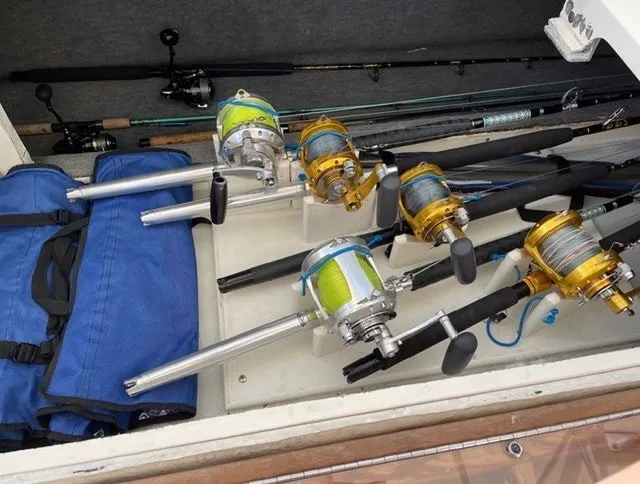 Slide: The Image of Fishing rods and reels in a boat storage compartment. - 19
